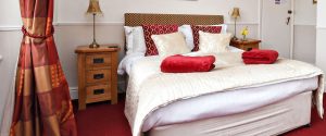 b&b room 1 with large bed and red decor